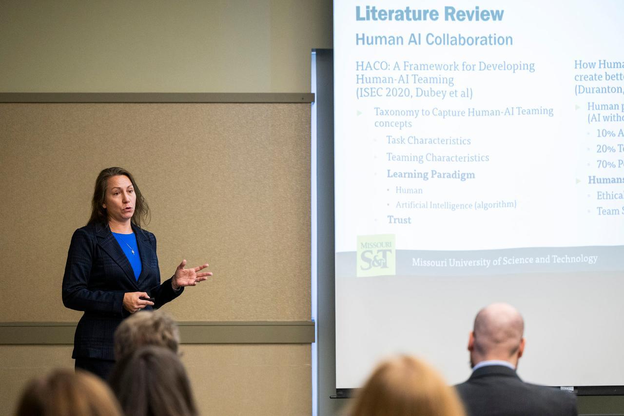 Students speaks in front of a group of people.