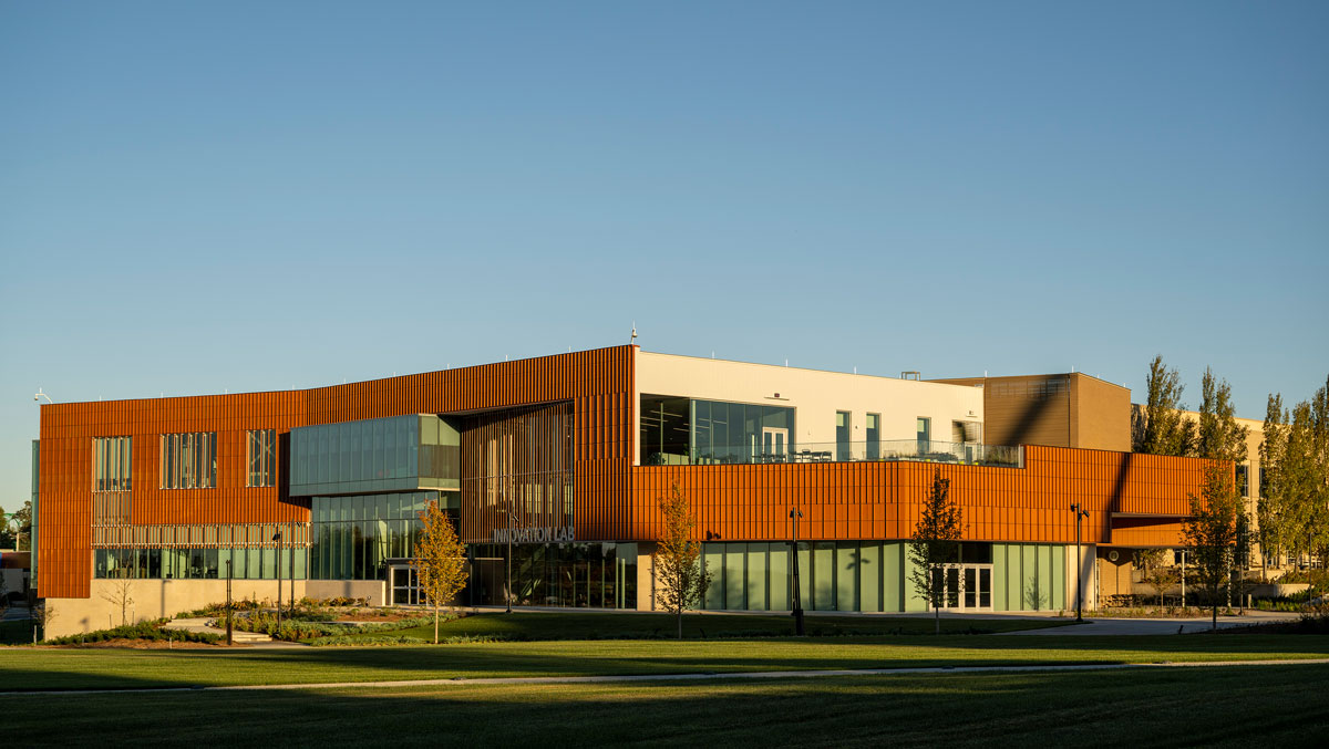 A modern two-story building with glass and orange paneling, labeled 