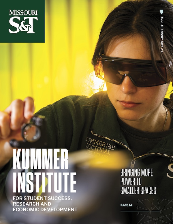 A woman wearing protective goggles works with scientific equipment in a laboratory. The cover features the Missouri S&T logo and text about the Kummer Institute, highlighting research, student success, and economic development.